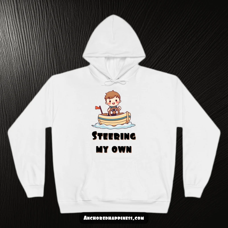 Funny hoodie featuring a cheerful figure comically steering a small, whimsical boat, offering warmth and nautical-themed amusement for all.